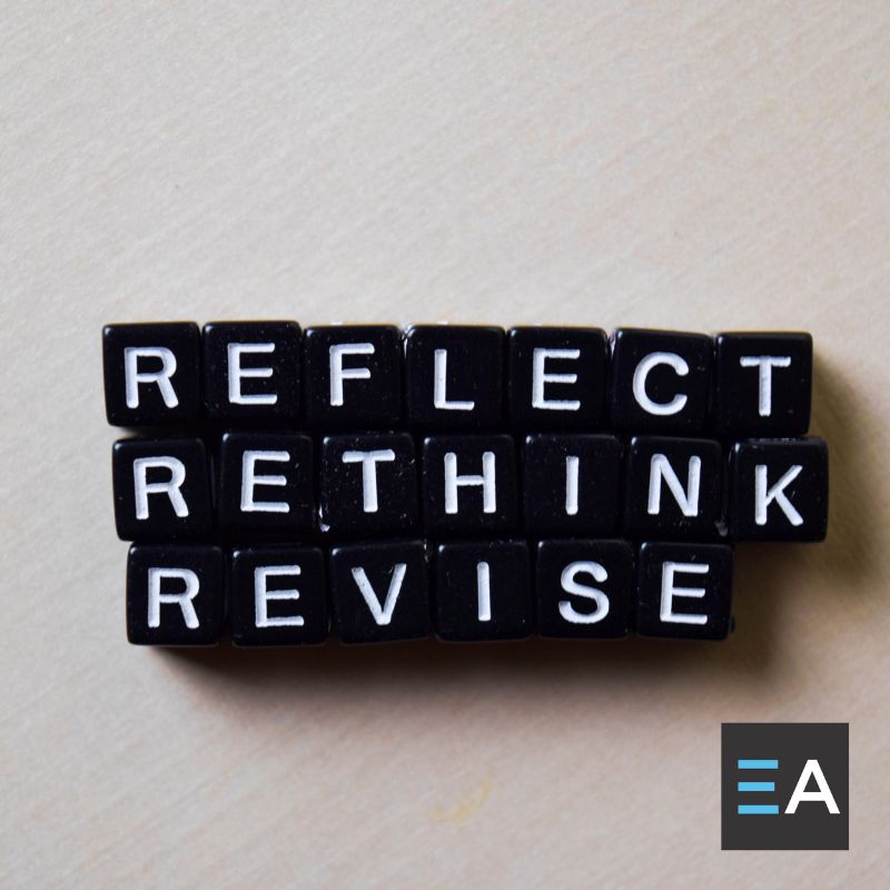 Black beads with white letters spelling out "reflect rethink revise"